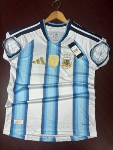 Argentina World Cup 2026 home jersey with sky blue and white stripes in player edition design. Close-up view of Argentina premium football jersey showing breathable lightweight fabric and heat press logo. Messi 10 Argentina home jersey with slim fit player edition style and modern athletic look. Argentina football jersey mockup featuring premium recycled polyester material and official-inspired design.